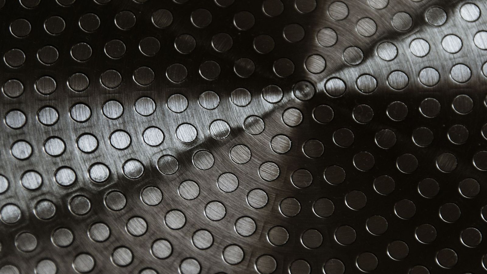Close-up of a dark surface with a raised circular pattern